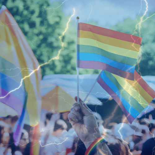 Crowd waving LGBTQ flags